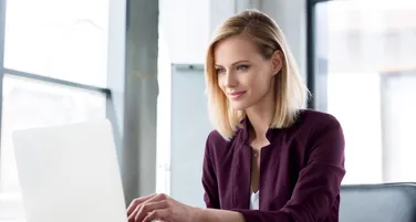 A woman at a laptop signing back in